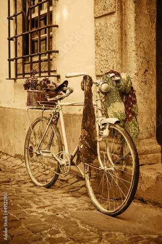 Vintage bicycle leaning against an old door in a medieval street