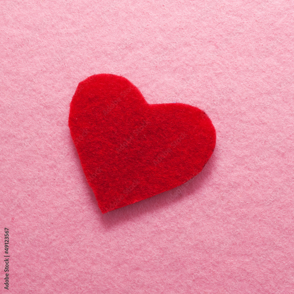 Fototapeta premium Felt red heart on pink background.