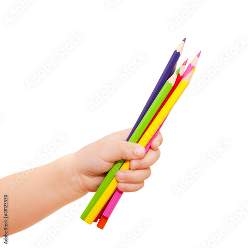 Kids hand holding few pencils.