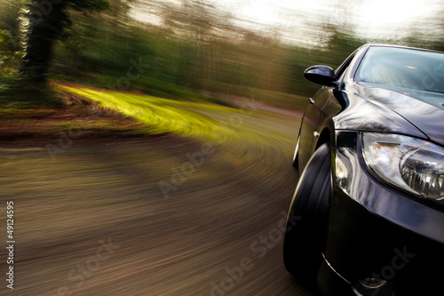 Side view of black car in turn with heavy blur motion