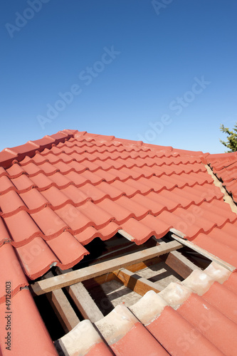 Damaged red tile roof construction