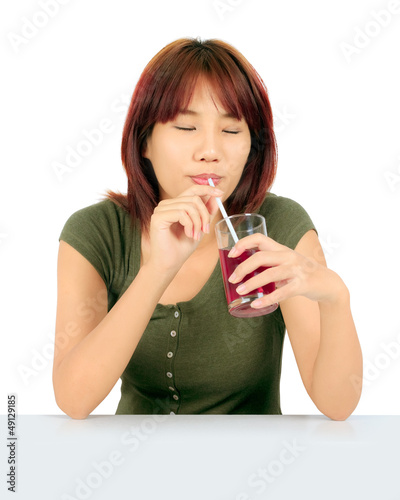 Isolated young asian woman with a cglass of grape juice photo