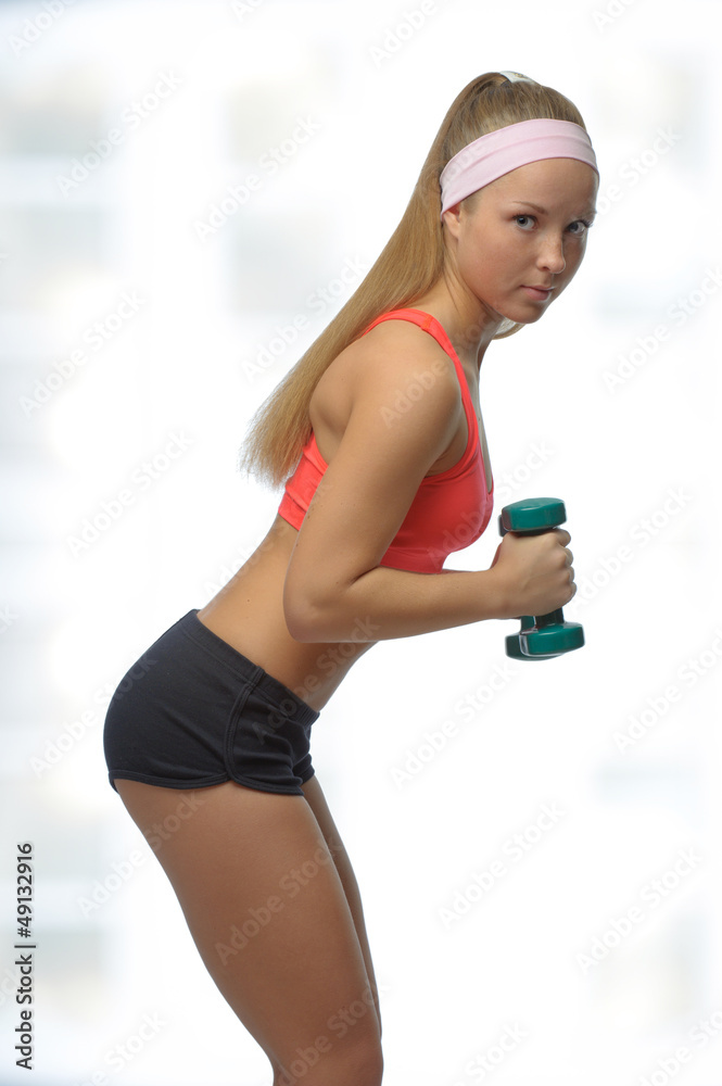 Image of blonde smiling woman with barbell in hand
