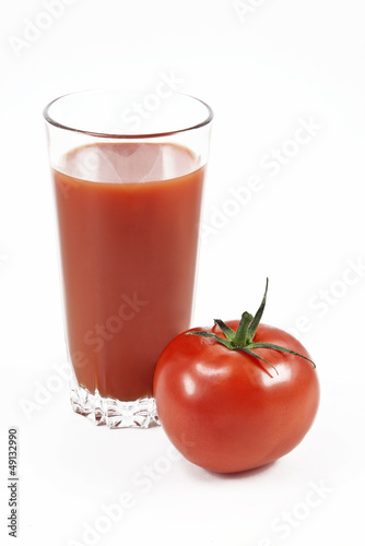 Tomato and juice in a glass on a white background © vesta48