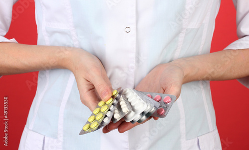 Close-up of female doctor hand holding pills,