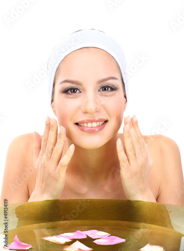 Young woman washing her fac...