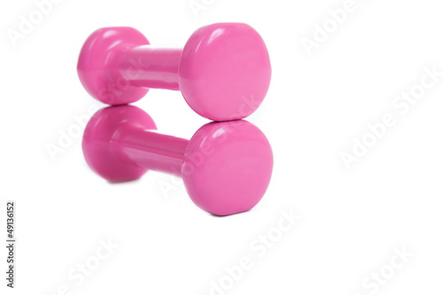 pink dumbbells on a white background © Black-photography