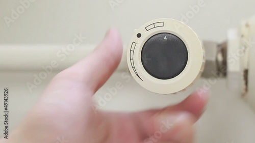 Radiator thermostat turned, selective focus, white background