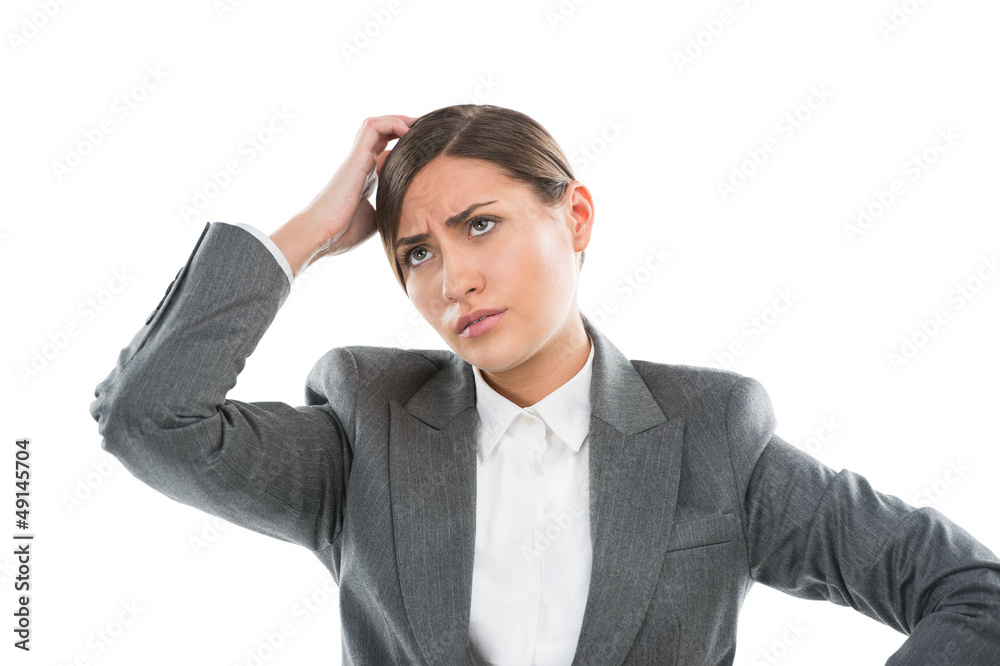 Portrait of confused female executive thinking on white backgrou Portrait of confused female executive thinking on white backgrou