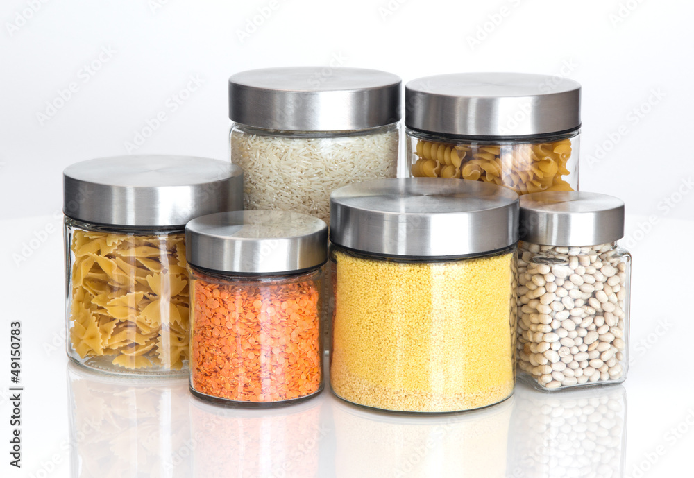 Food ingredients in glass jars, on white background Food ingredients in glass jars, on white background