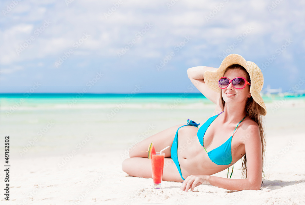 woman in bikini with fresn watermelon juice on tropical beach