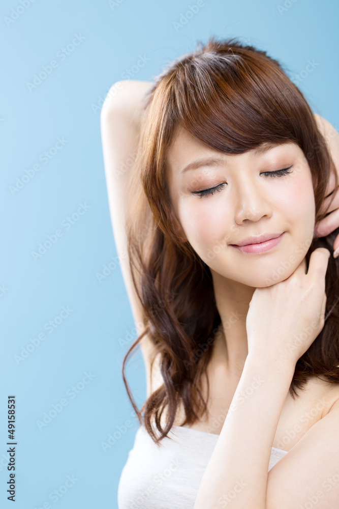 Fototapeta premium Beautiful asian woman on blue background