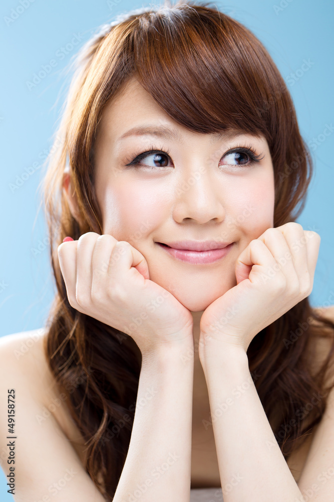 Fototapeta premium Beautiful asian woman on blue background