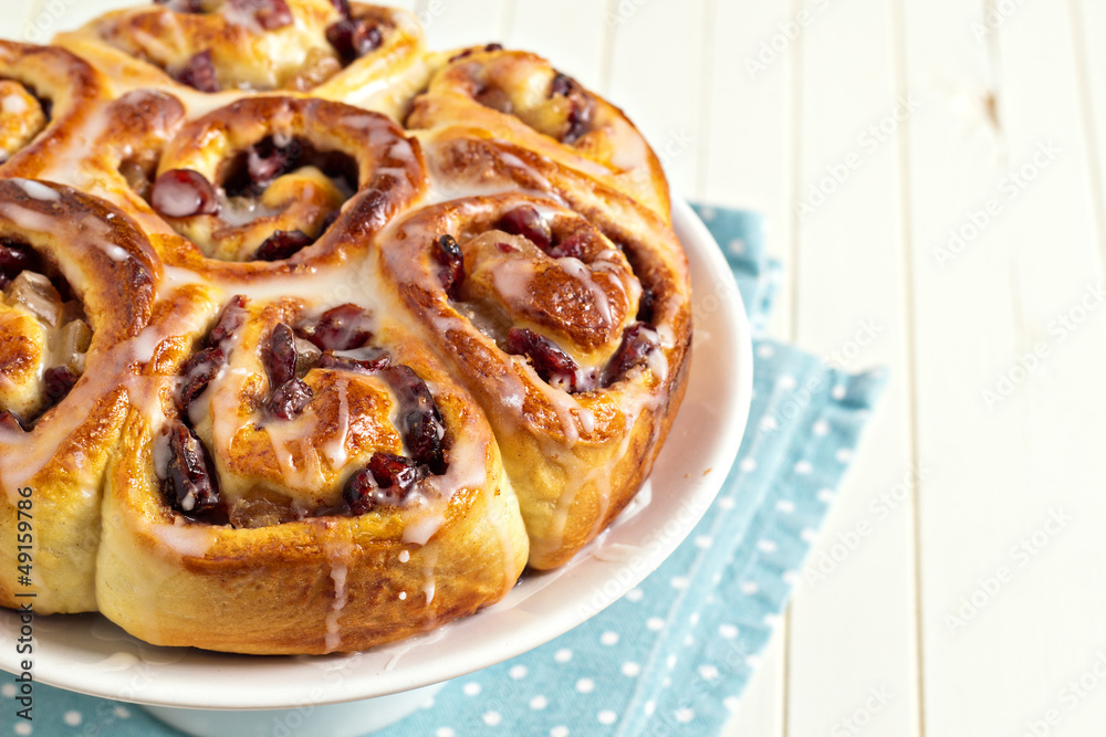 Sweet rolls with dried fruits and dripping glaze with copy space