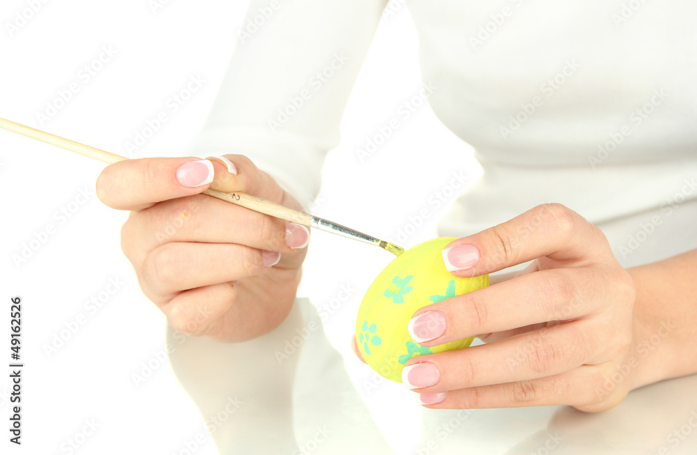 Young woman painting Easter egg, isolated on white Young woman painting Easter egg, isolated on white