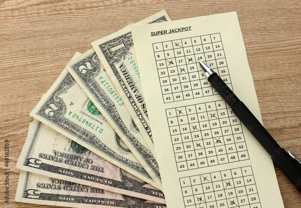 Lottery ticket with pen and money, on wooden background Lottery ticket with pen and money, on wooden background