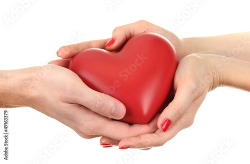 Red heart in woman and man hands  isolated on white