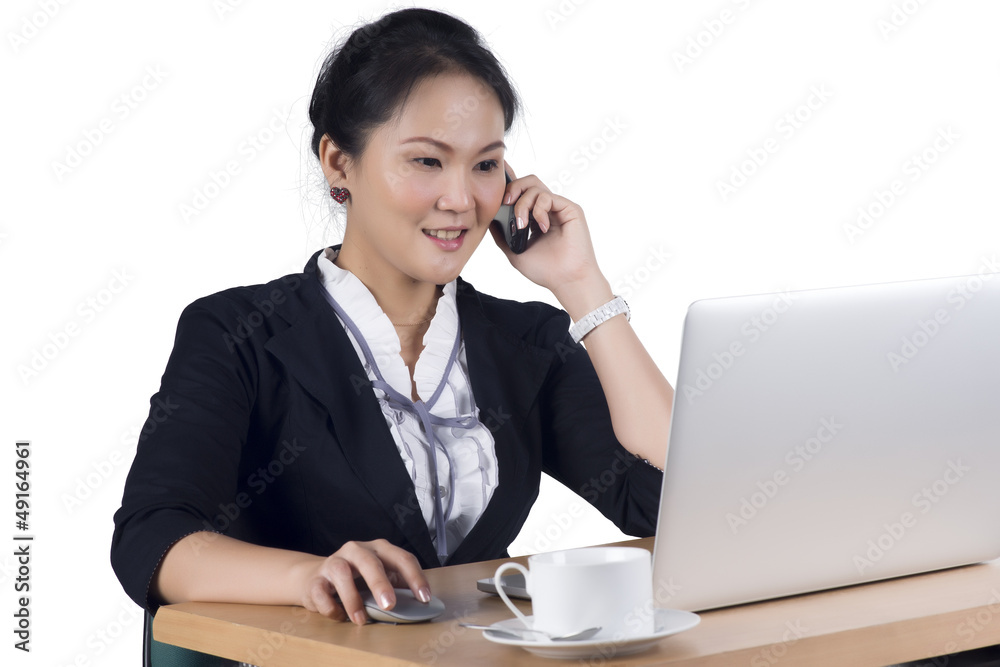 Portrait of business woman speaking on mobile phone while using Portrait of business woman speaking on mobile phone while using