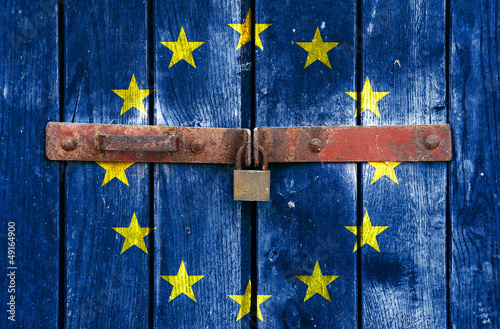European Union flag on the background of old locked doors #49164900