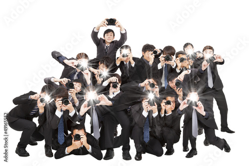 many photograper holding camera pointing to you and isolated on photo
