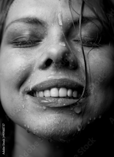 Portrait of a girl's face which water flows