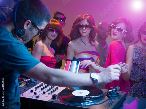 dj playing music with turntables sunglasses colorful lights