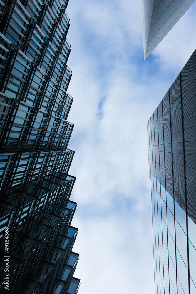 Naklejka premium High modern buildings on the background of blue sky