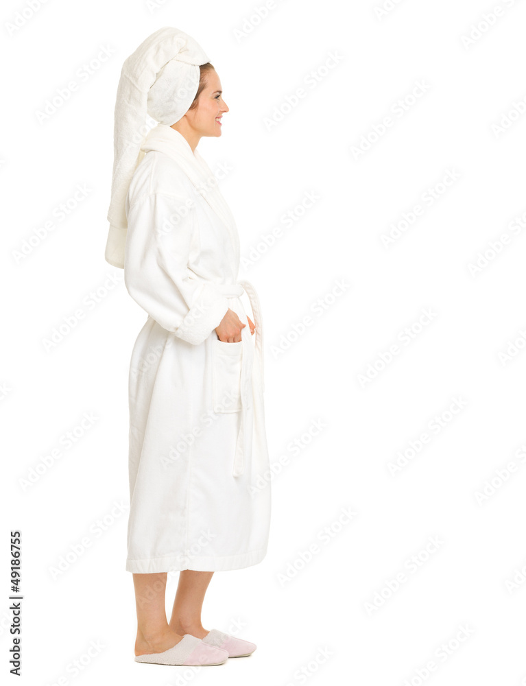 Full length portrait of woman in bathrobe looking on copy space