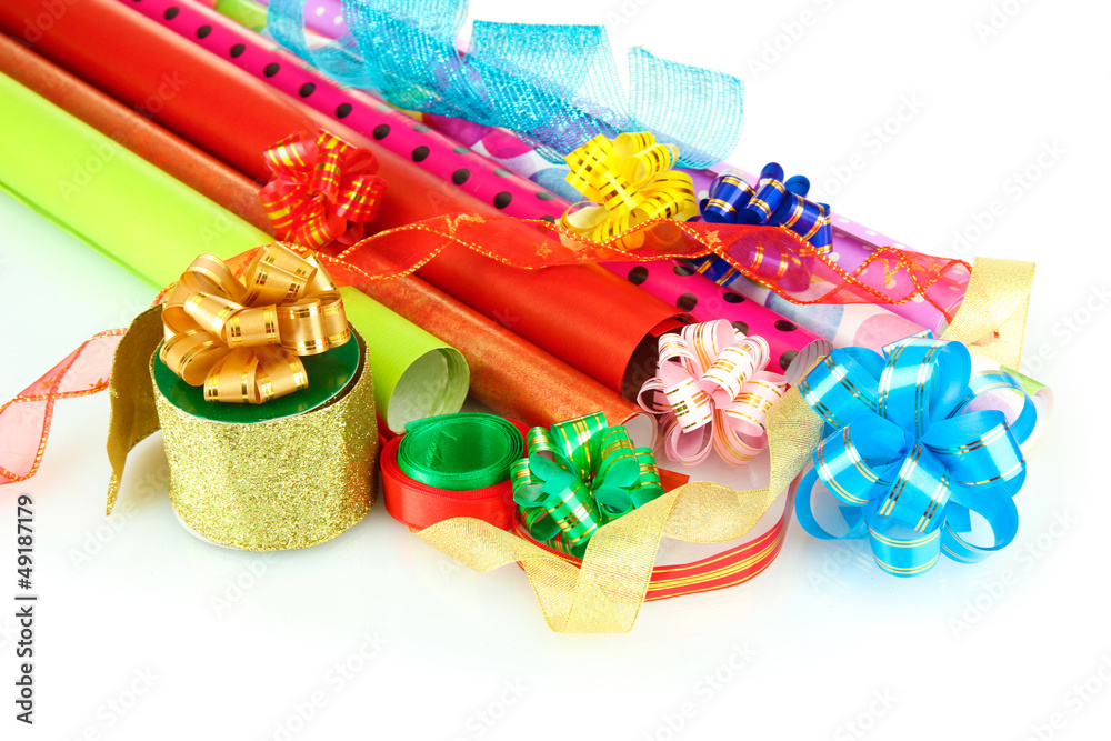 Rolls of Christmas wrapping paper with ribbons, bows isolated