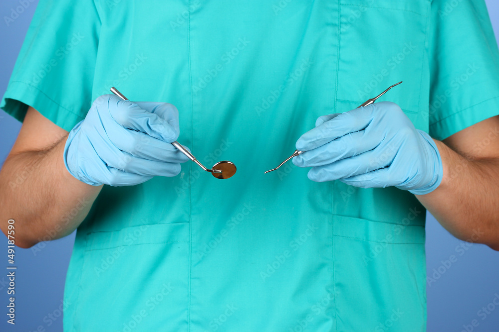 Doctor with medical instruments, on blue background
