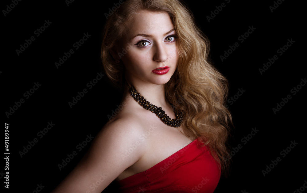 Portrait of Woman in red dress. attractive girl with curly hair Portrait of Woman in red dress. attractive girl with curly hair