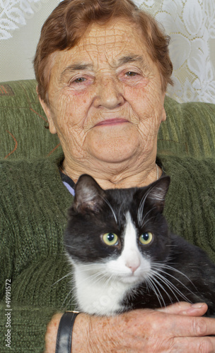 The grandmother with a cat on a sofa