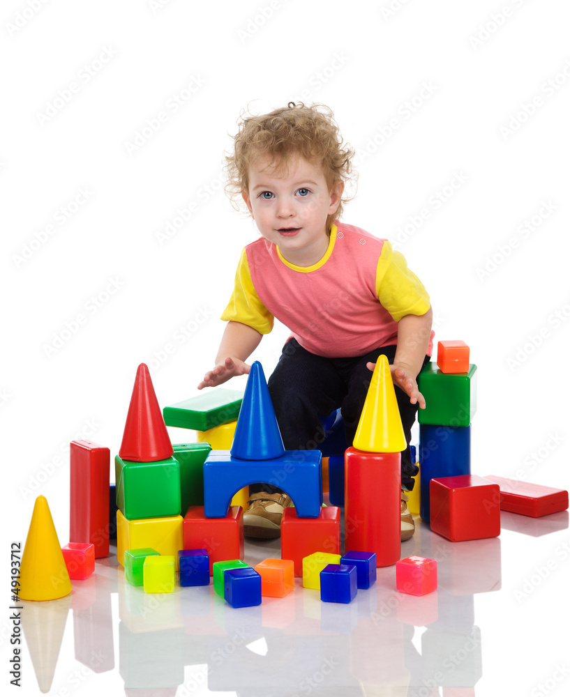 little boy playing with building blocks. Isolated on white little boy playing with building blocks. Isolated on white