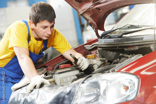 car mechanic with sparking plug