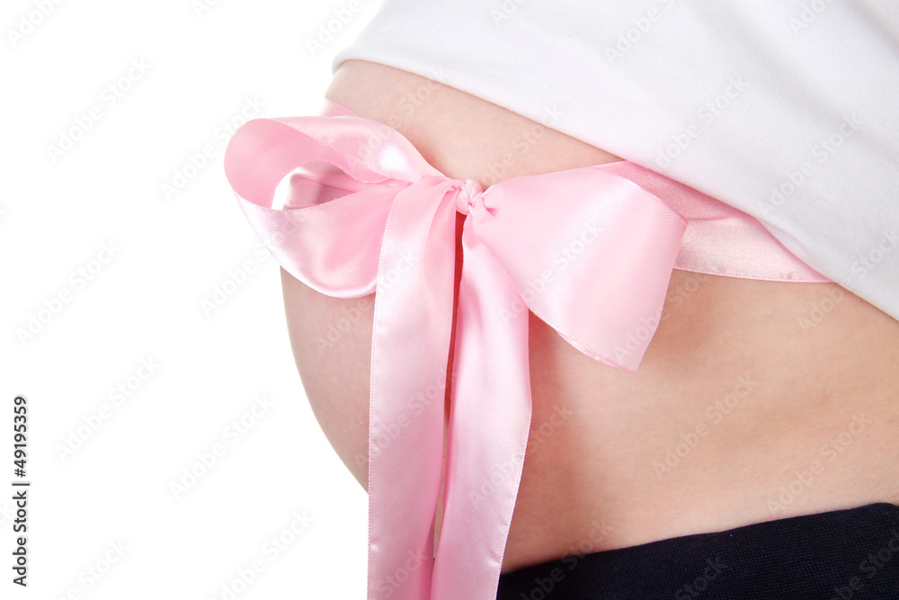 Abdomen a young pregnant woman with a pink ribbon Abdomen a young pregnant woman with a pink ribbon
