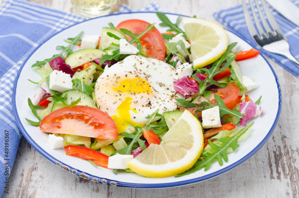 Vegetable salad with poached egg on a plate, horizontal