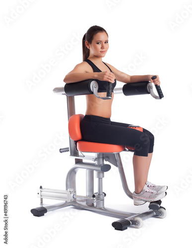 Brunette young woman on exerciser photo