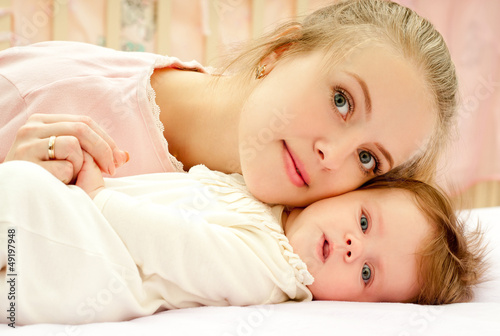 young mother and baby daughter at home