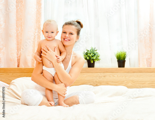 Mother and daughter play in the bedroom