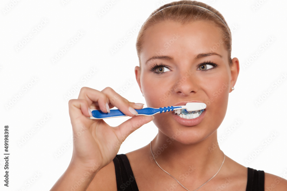 Young Caucasian woman brushing her teeth