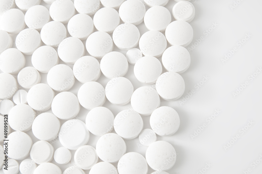 White pills on white background - medical concept White pills on white background - medical concept