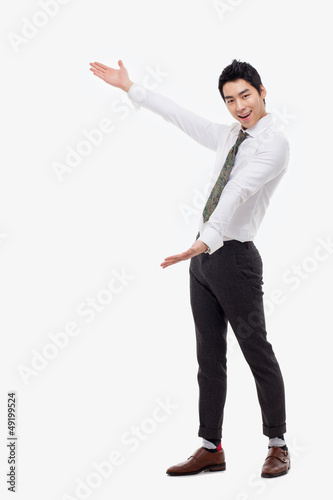 Young Asian business man showing something