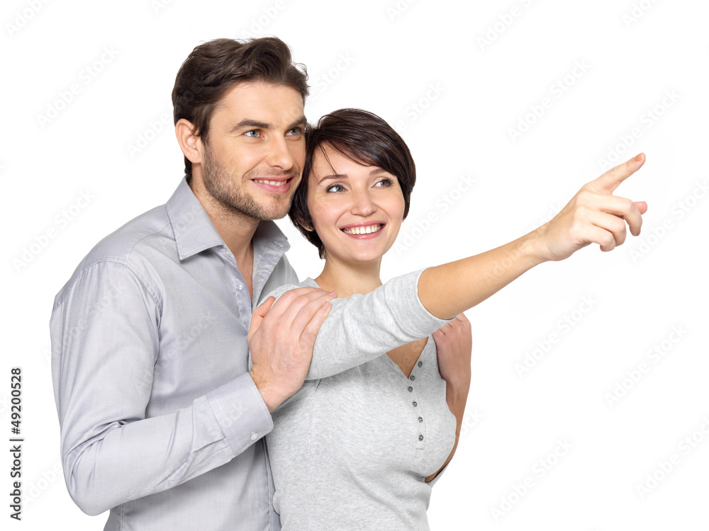 happy couple looking and pointing into the distance happy couple looking and pointing into the distance