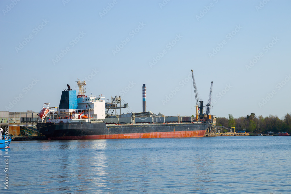 Loading cargo ship in port Gdansk, Poland.