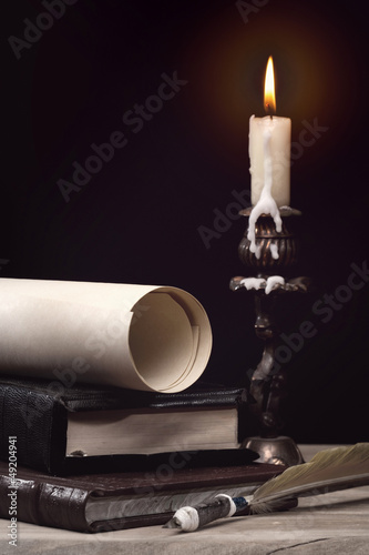 Art still life with burning candle over old wooden desk
