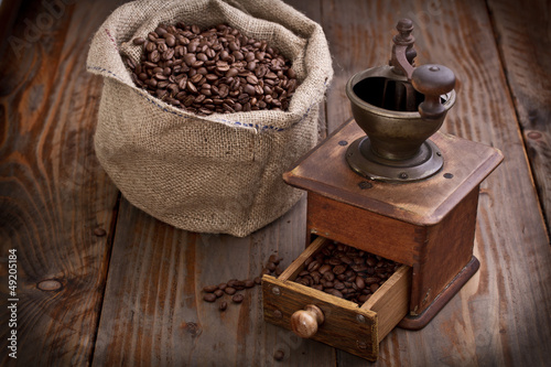 old Coffee Mill with beans and burlap