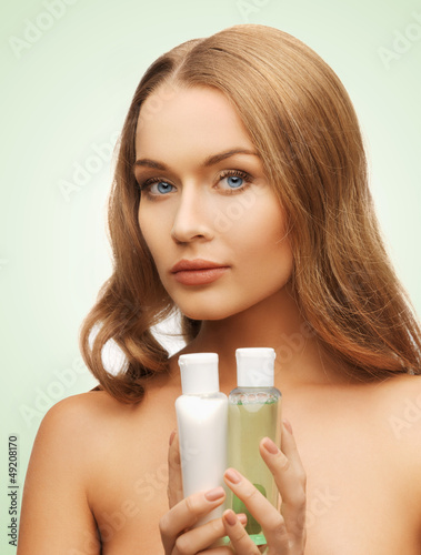 woman with cosmetic bottles