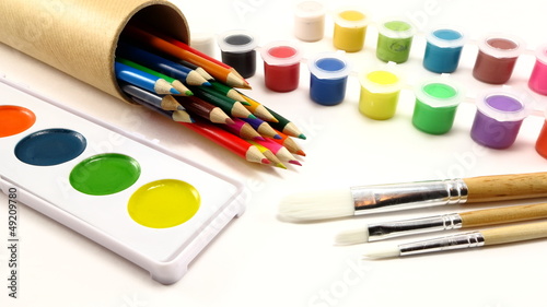 Colored pencils, paint brushes, and paint supplies