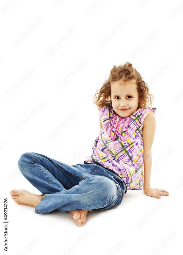 Pretty little girl sitting on the floor in jeans Pretty little girl sitting on the floor in jeans