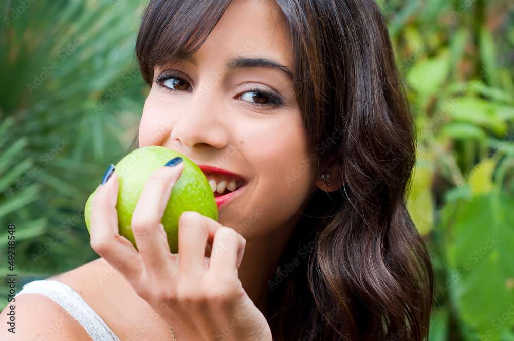 Young womans portrait holding an apple Young womans portrait holding an apple